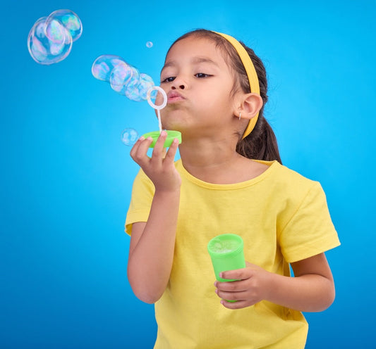 child blowing bubbles to breathe for self-regulation