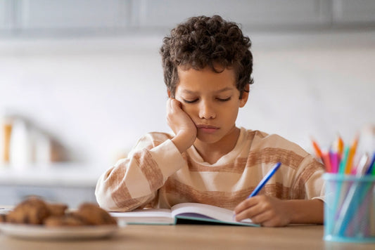 boy unhappy writing