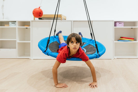 child in a therapy swing in an ideal sensory space