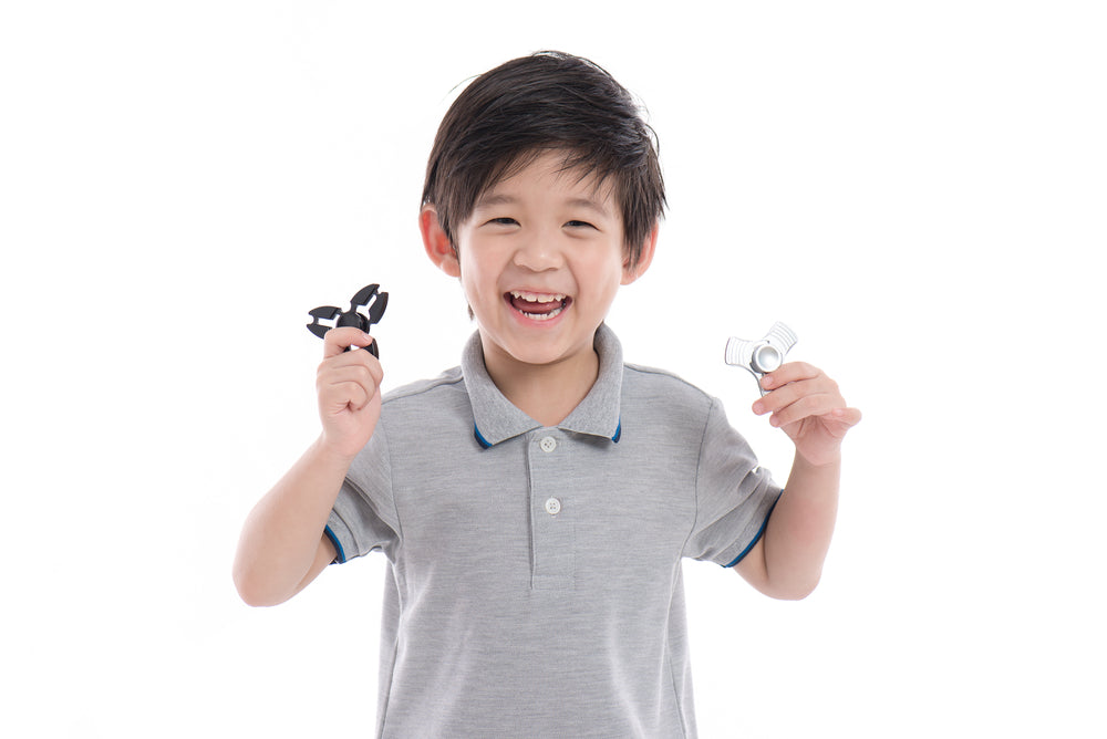 boy holding fidget spinners