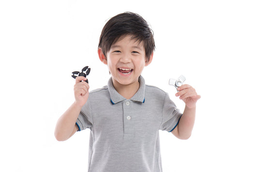 boy holding fidget spinners