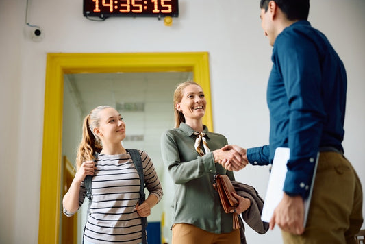 teacher shaking parent's hand